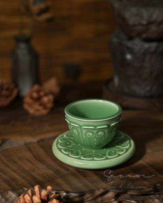 Song Dynasty style Longquan celadon teacup set with saucer, imperial-inspired design and traditional carved Baoxiang motif.