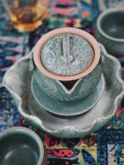 On-the-go tea luxury: full-sized Yixing teapot with auspicious clouds, large catch-all tray, and space-saving design for travelers.