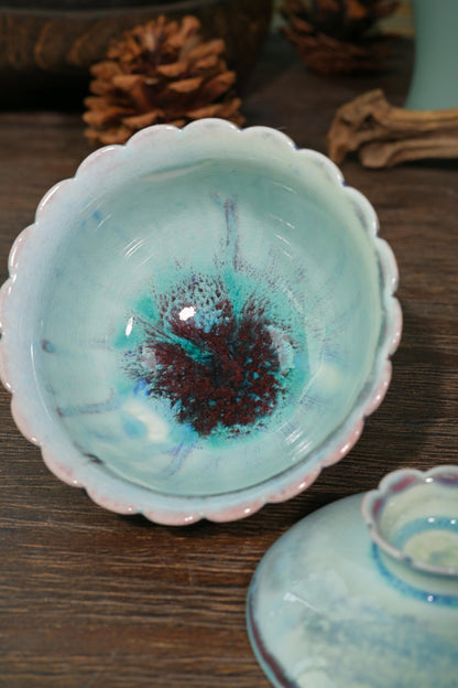 Handcrafted wood-fired tea bowl featuring carved petal lid knob and scalloped foot ring