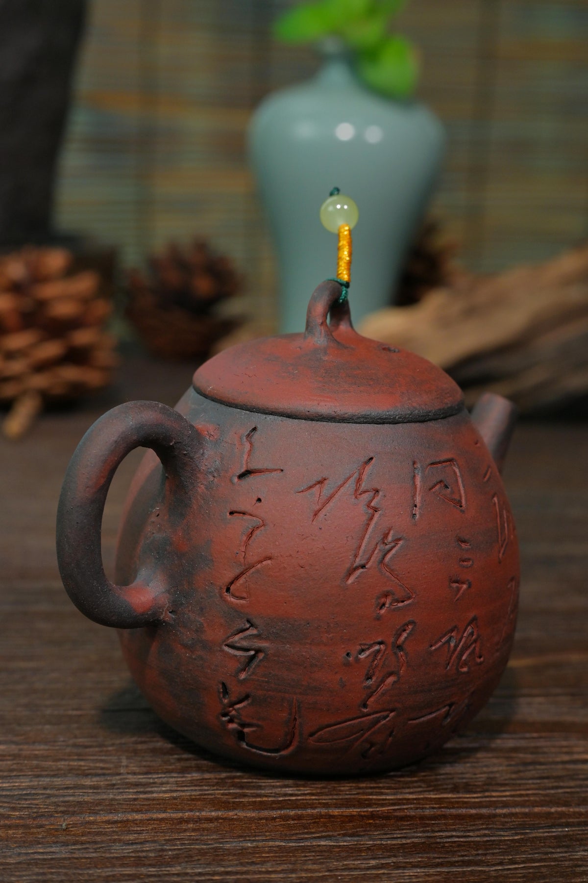 Handcrafted 100ml unglazed iron-rich clay teapot featuring arched bridge lid knob and beaded cord accent