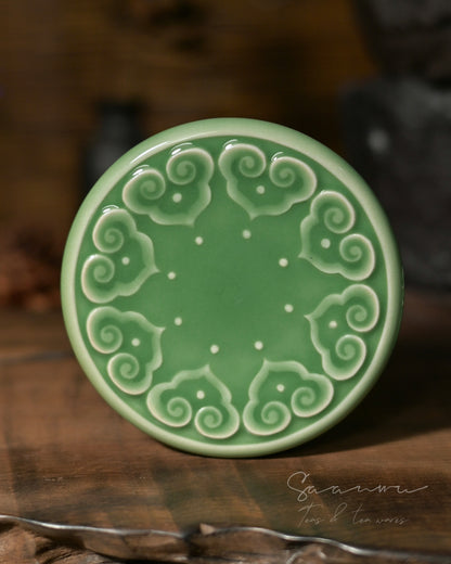 Elegant Chinese celadon tea cup with saucer, Di kiln style ceramic with carved Baoxiang decoration and smooth jade glaze.