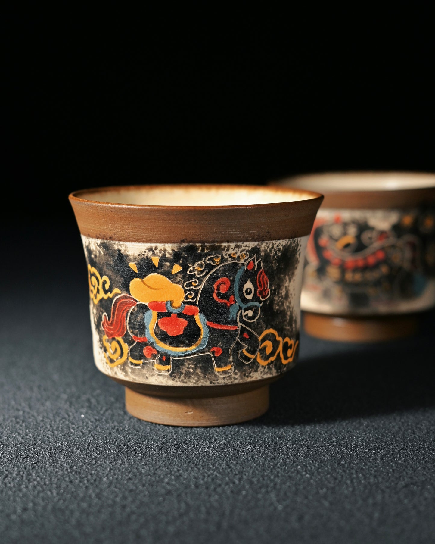 Chinese ink painting technique applied directly on teacup surface using fine brushwork and mineral pigments