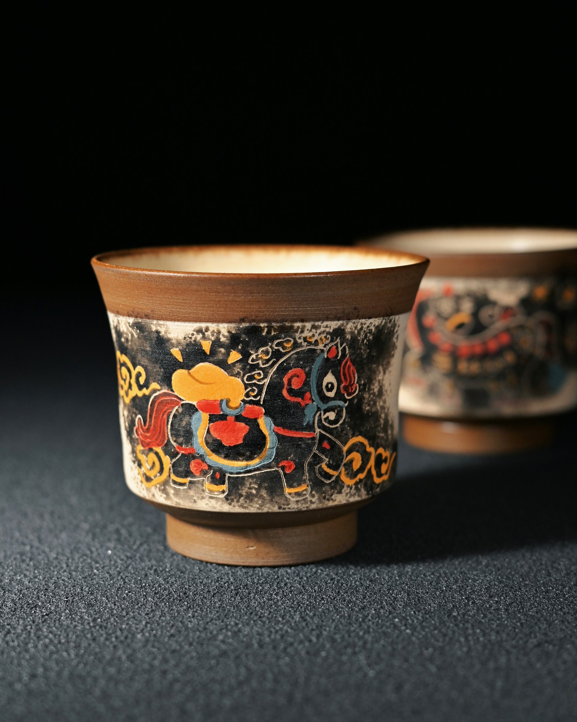 Chinese ink painting technique applied directly on teacup surface using fine brushwork and mineral pigments