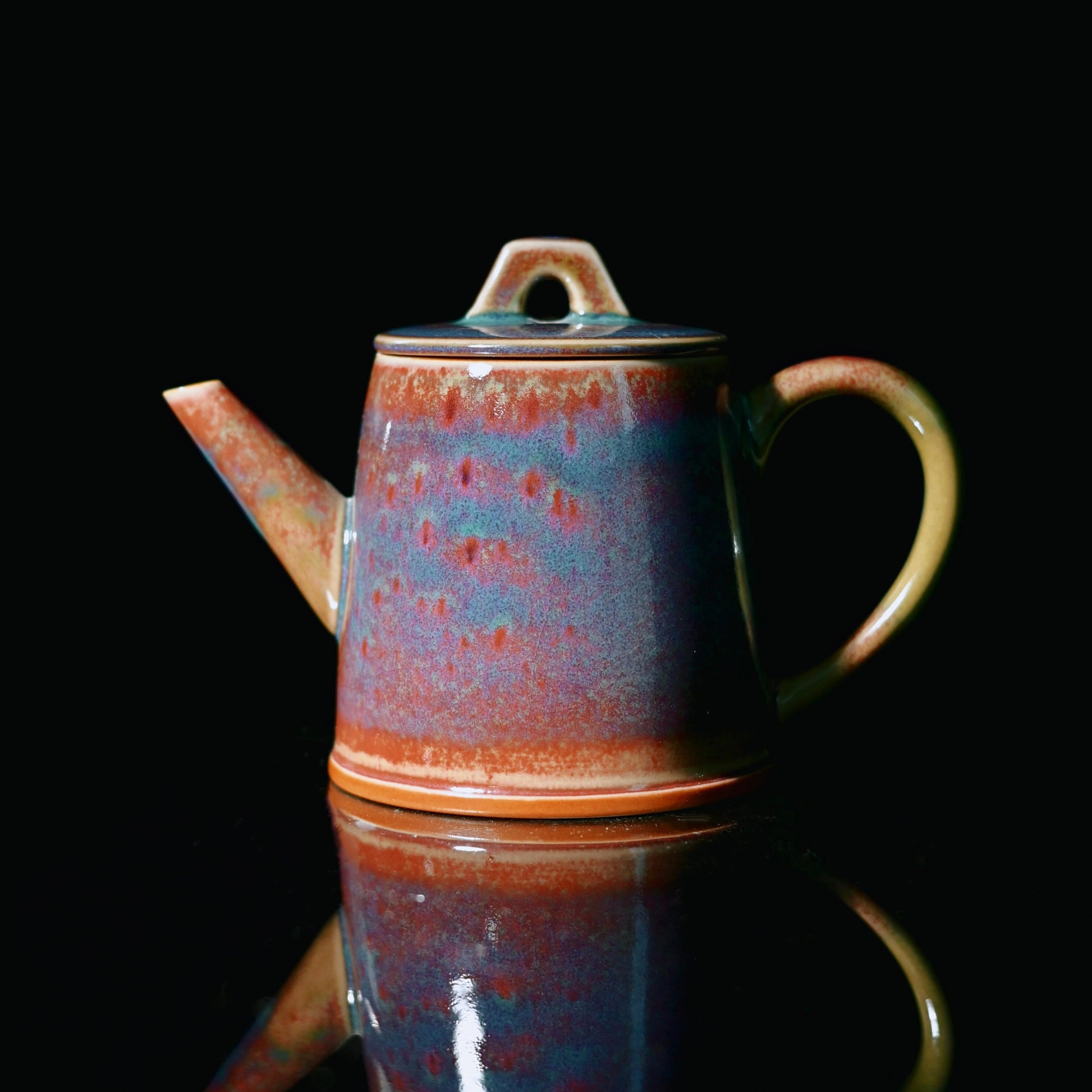 Jun Ware teapot featuring kiln-transformed glaze in purple, red and blue hues