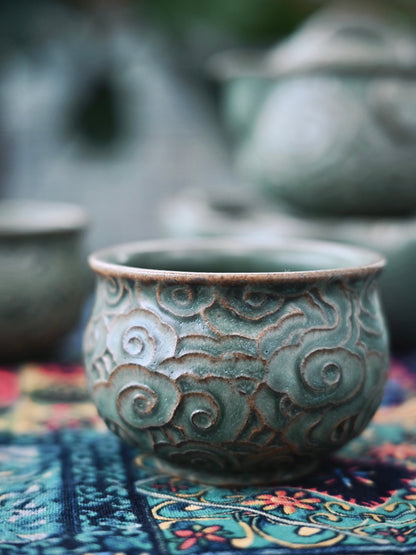 Portable travel tea set with carved cloud Yixing teapot, large capacity tea tray, and compact cups for tea on-the-go.
