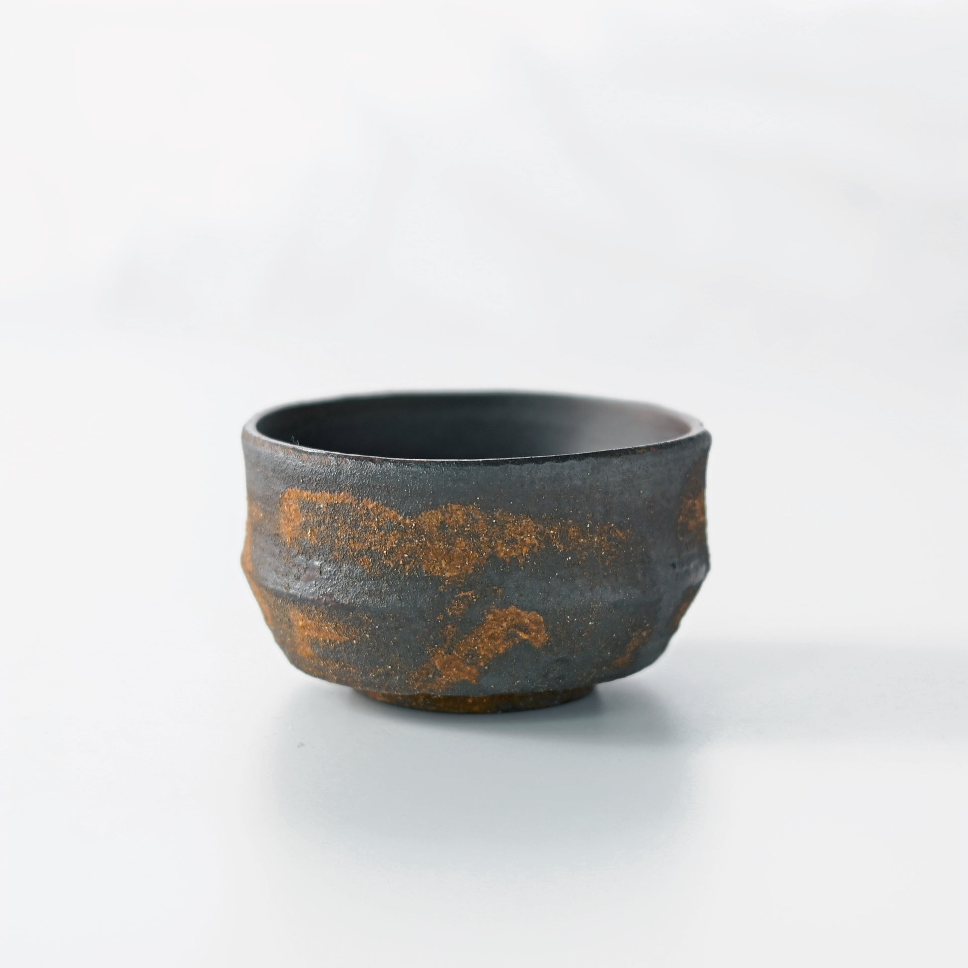 Coarse clay master cup with substantial weight and ergonomic form for host's personal use