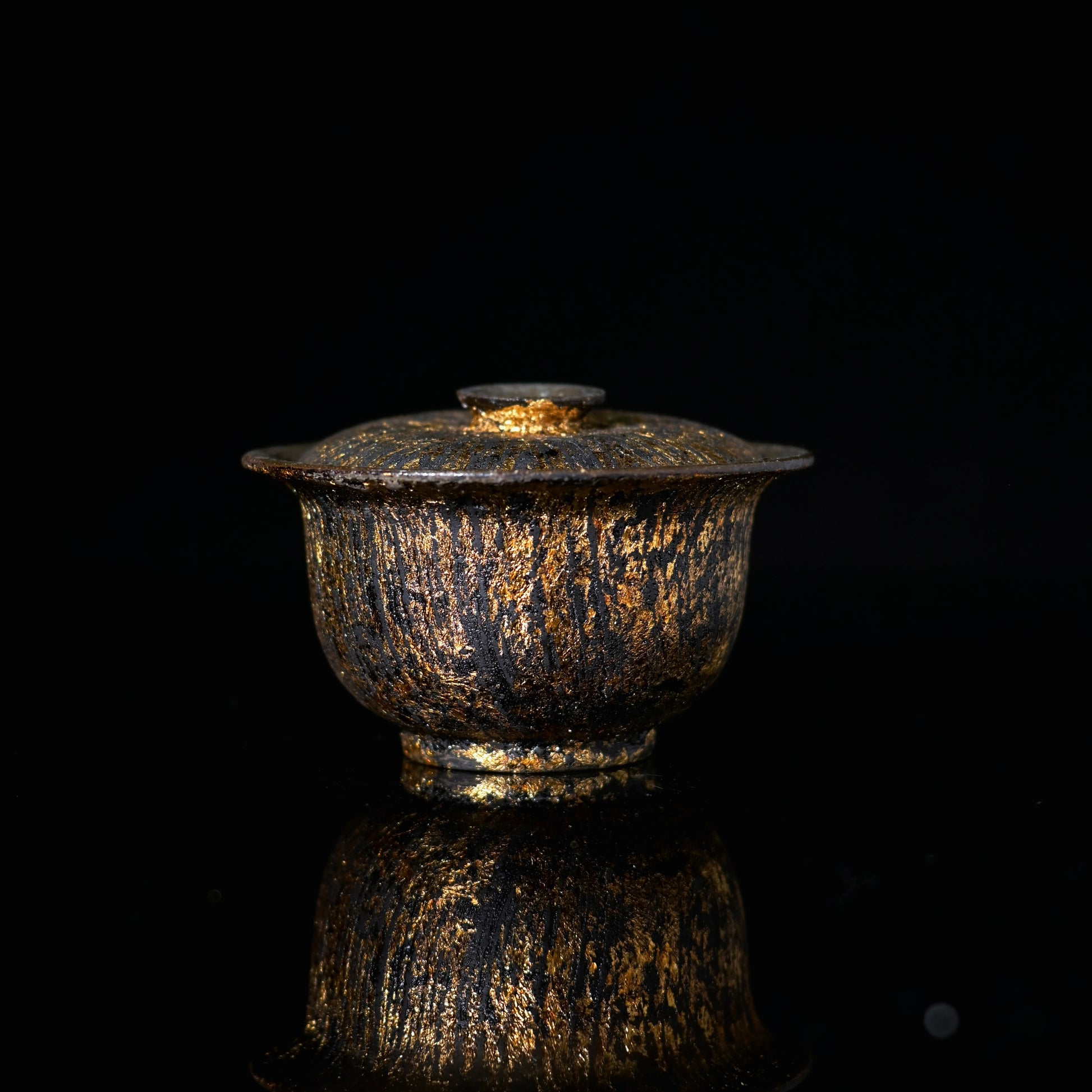 SAANWU handmade coarse clay gaiwan, natural raw lacquer with hand brushed gold streaks, luxury wabi sabi tea ware on black reflective background