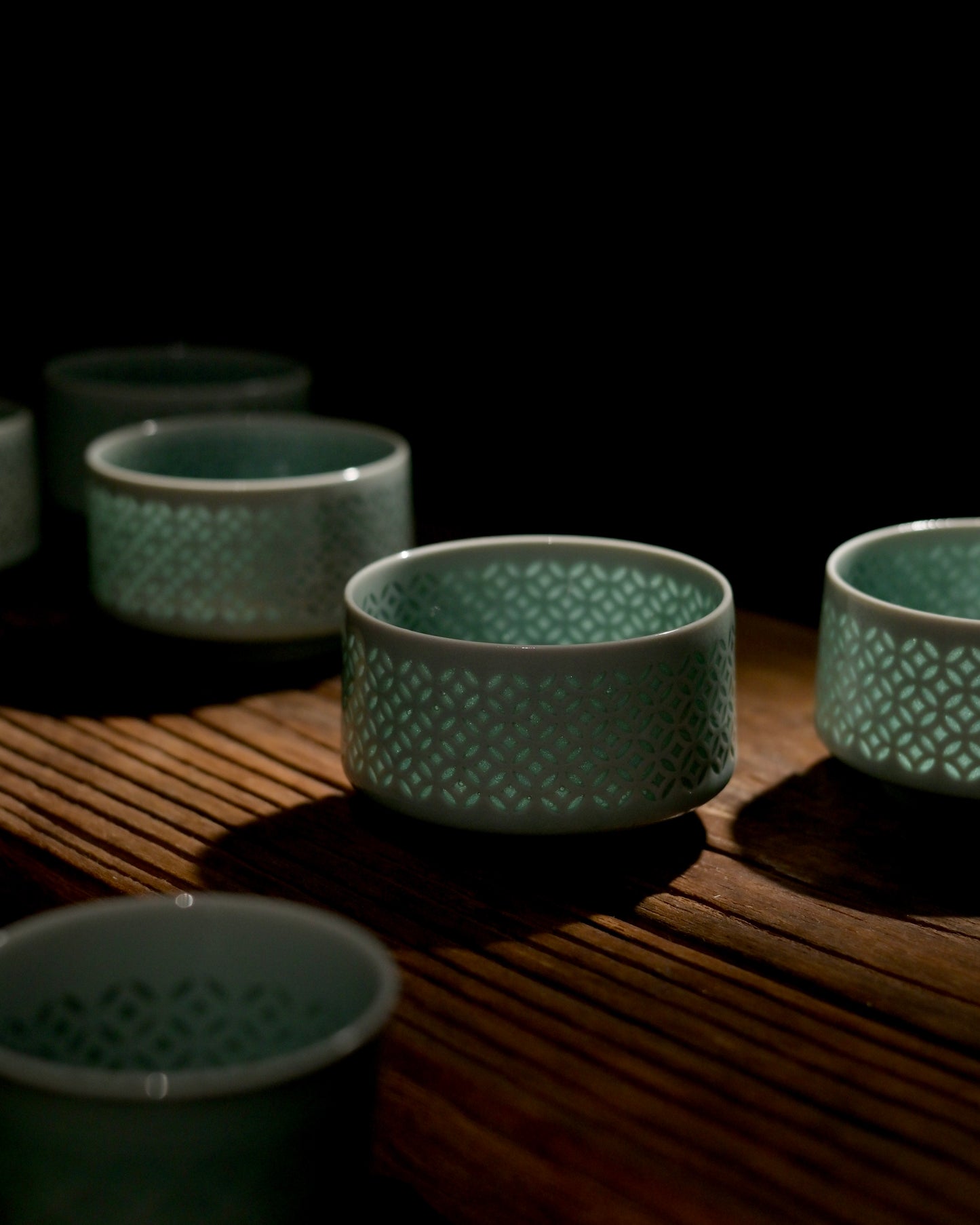 Interlocking coin lattice linglong porcelain Longquan tea cup, traditional hollow craft jade green celadon home tea room decor