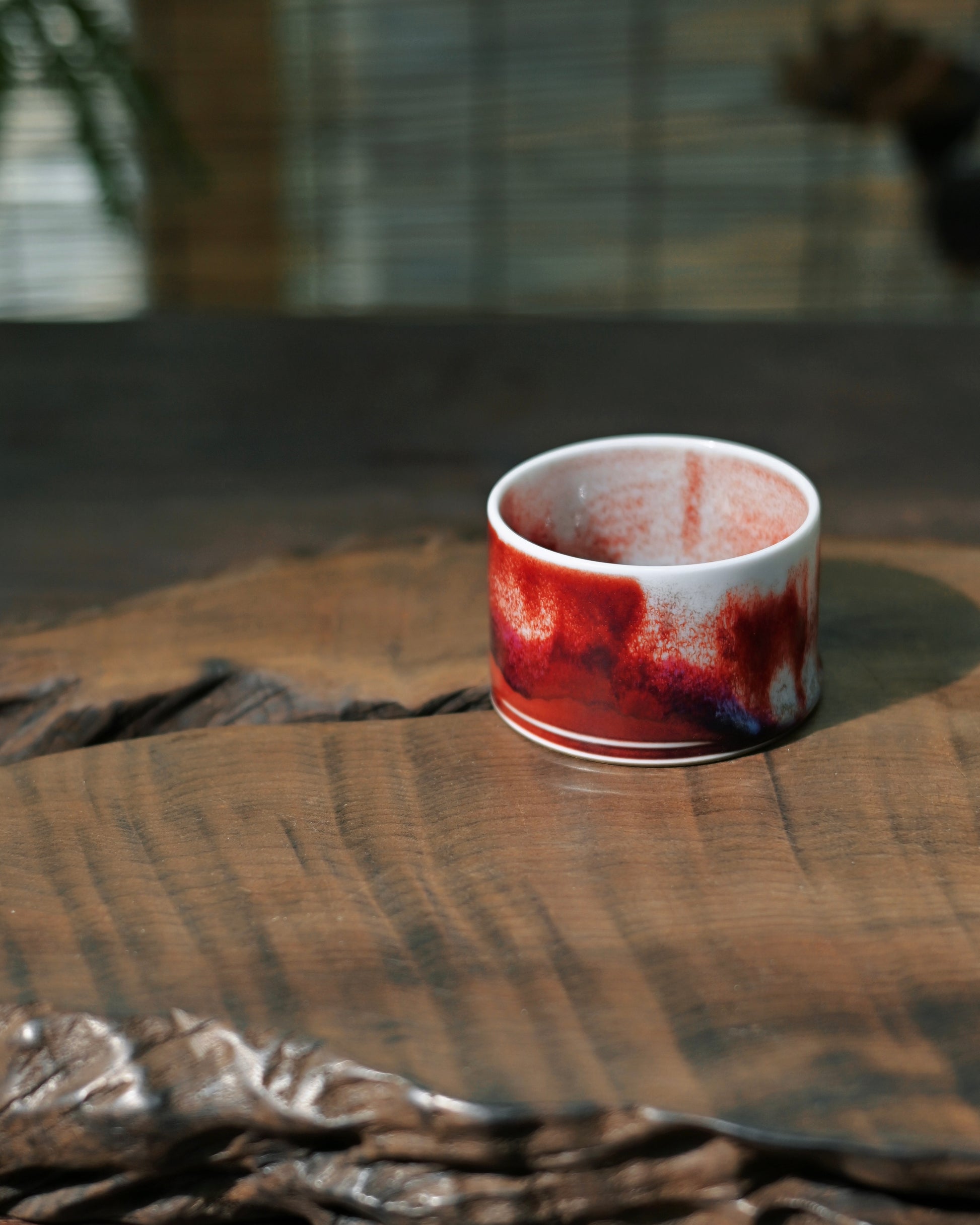 Copper and iron mineral glaze creating layered violet tones in Jun ware ceramic