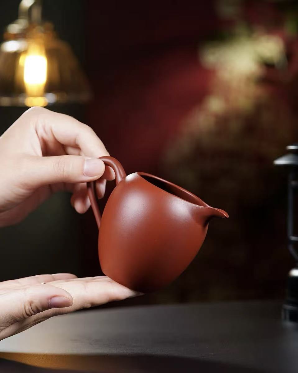 Close-up view of rare Da Hong Pao clay texture with metallic luster and smooth surface