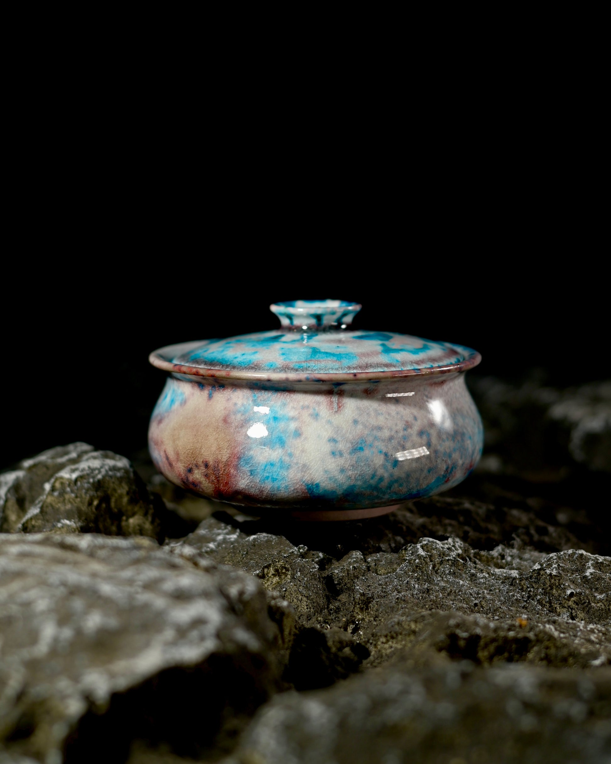 Vibrant crystalline glaze resembling sapphire and ruby tones, created through natural kiln transformation.