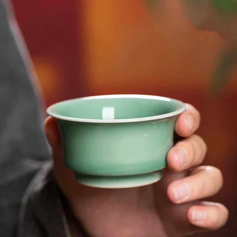 Authentic Chinese Longquan Celadon Teacup Featuring a Delicate Embossed Koi Fish Pattern, Ideal for Tea Lovers and Collectors of Handmade Ceramics.