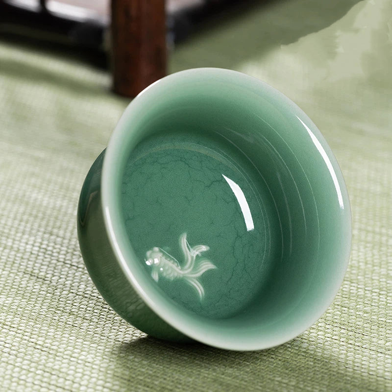 Elegant Longquan Celadon Koi Fish Embossed Teacup, Crafted from Fine Porcelain with Classic Jade Green Glaze and Symbolic Fish Motif for Prosperity.