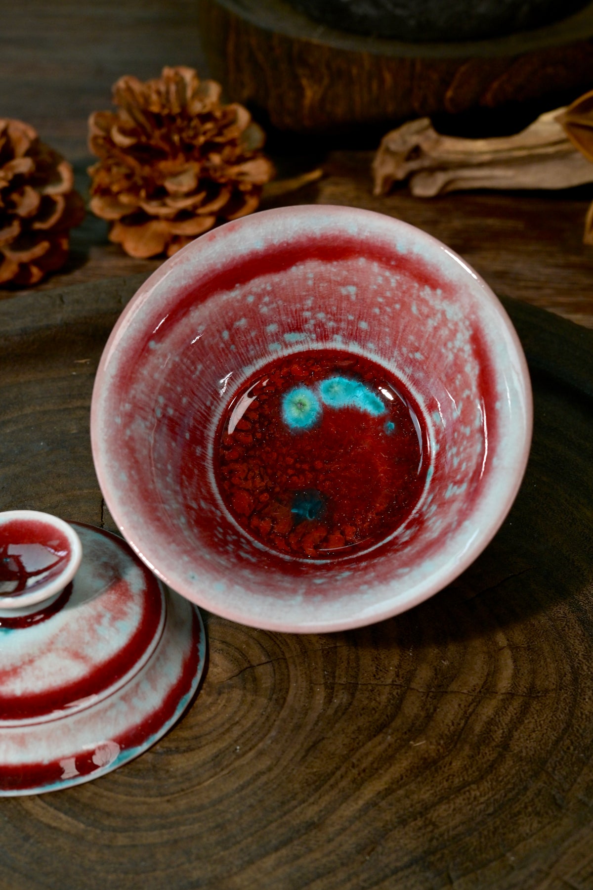 One-of-a-kind wood-fired bamboo segment Gaiwan displaying vibrant crimson glaze melts
