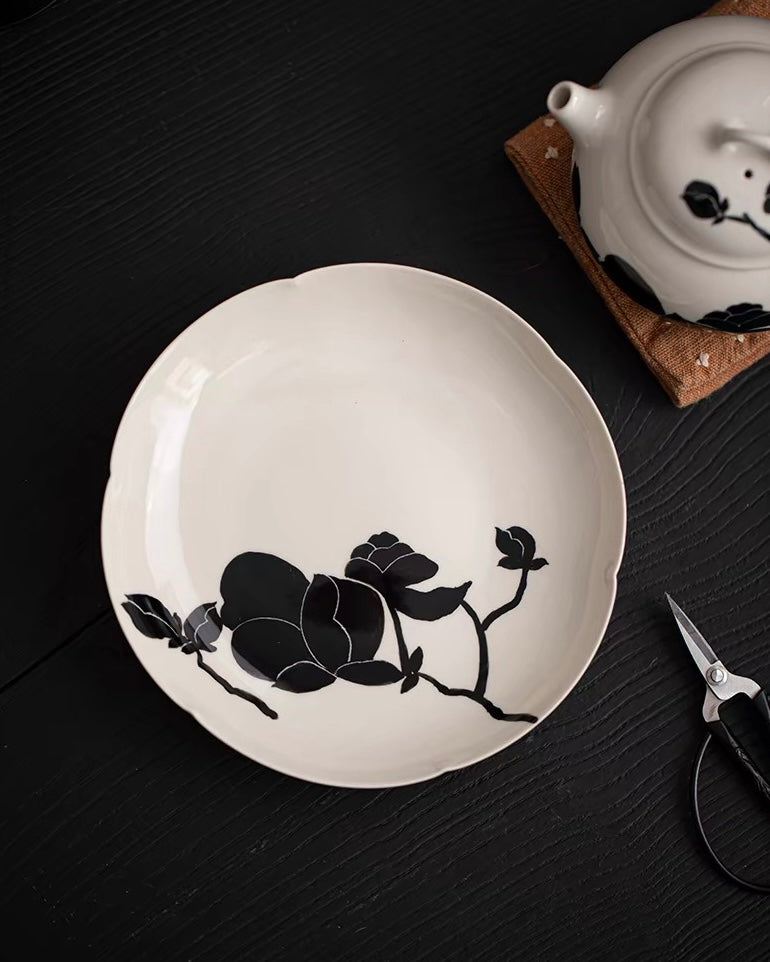 Ceramic tea tray with black magnolia pattern and plant ash glaze, featuring functional flower-shaped rim