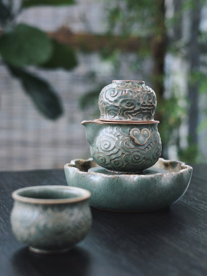 Green glaze vintage teaware set where swirling clouds seem to float across the surface of this hand-sculpted Yixing clay tea ceremony collection.