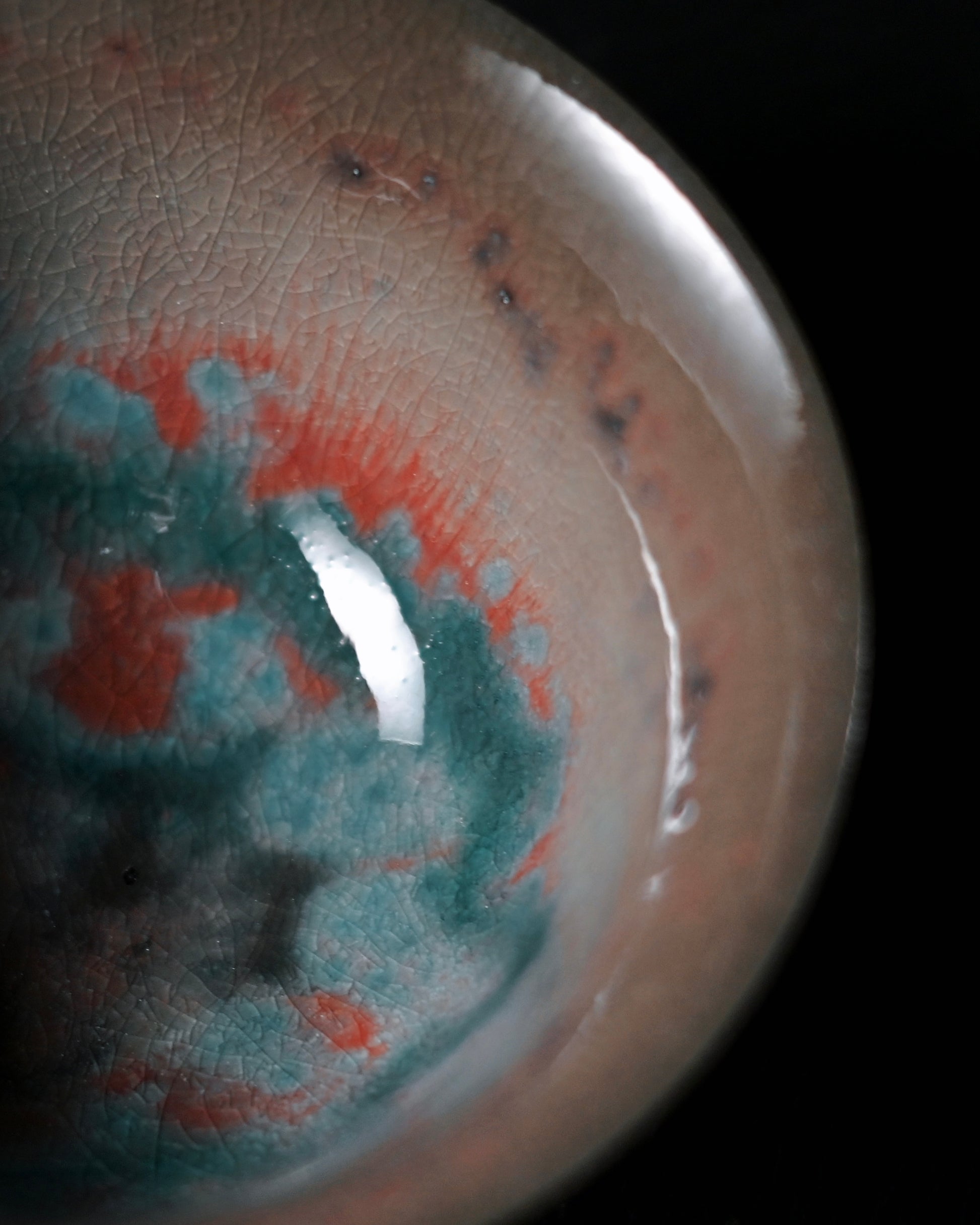 Handmade crystalline glaze tea bowl featuring starry celestial patterns and kiln sweat imperfections from wood firing