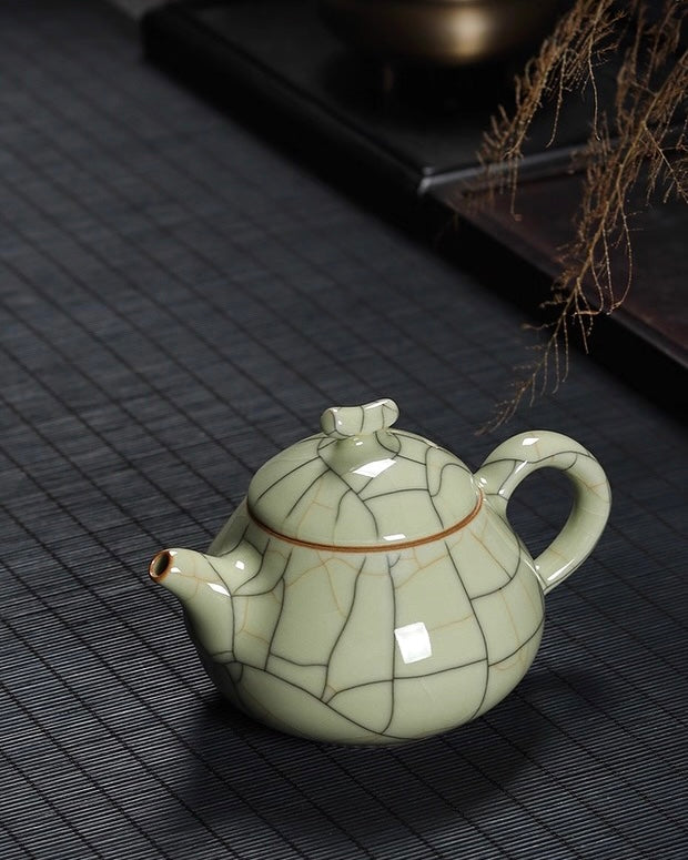 Pear shape teapot with angled spout and bamboo-style handle