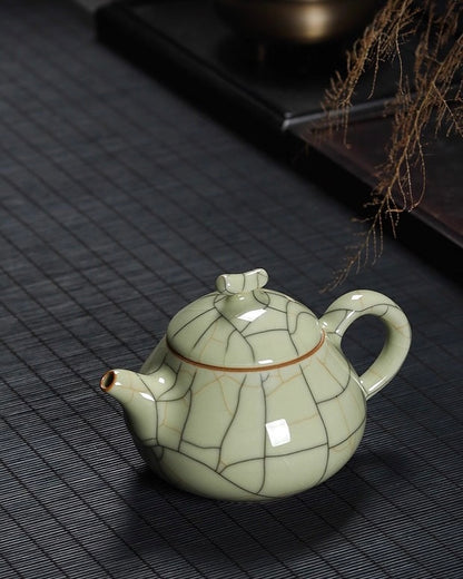 Pear shape teapot with angled spout and bamboo-style handle