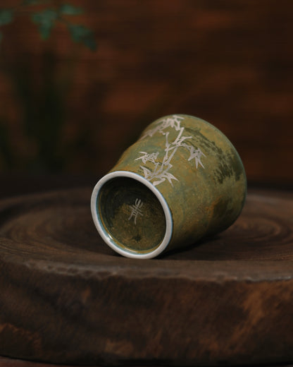 Delicate silver gilted bamboo decoration captured in natural daylight, highlighting its subtle metallic sheen against the matte glaze