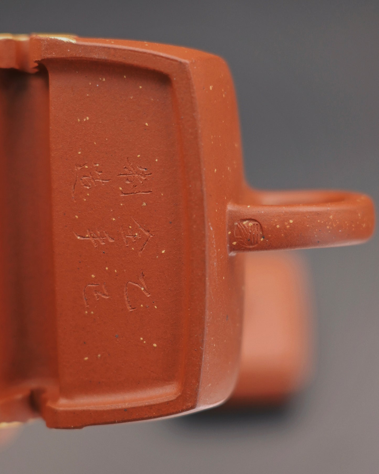 Yixing teapot with gold-painted outline highlighting carved design