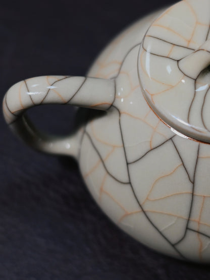 Ge Kiln-inspired Shippiao teapot: Longquan celadon with golden crackle networks on beige glaze, traditional iron clay body, and flawless tea stream