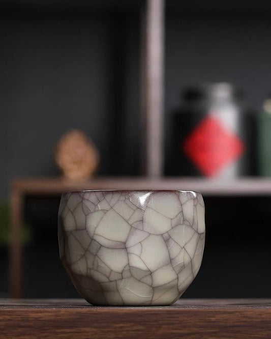 1350°C high-fired celadon teacup with faceted surface designed for visual light play and tactile grip