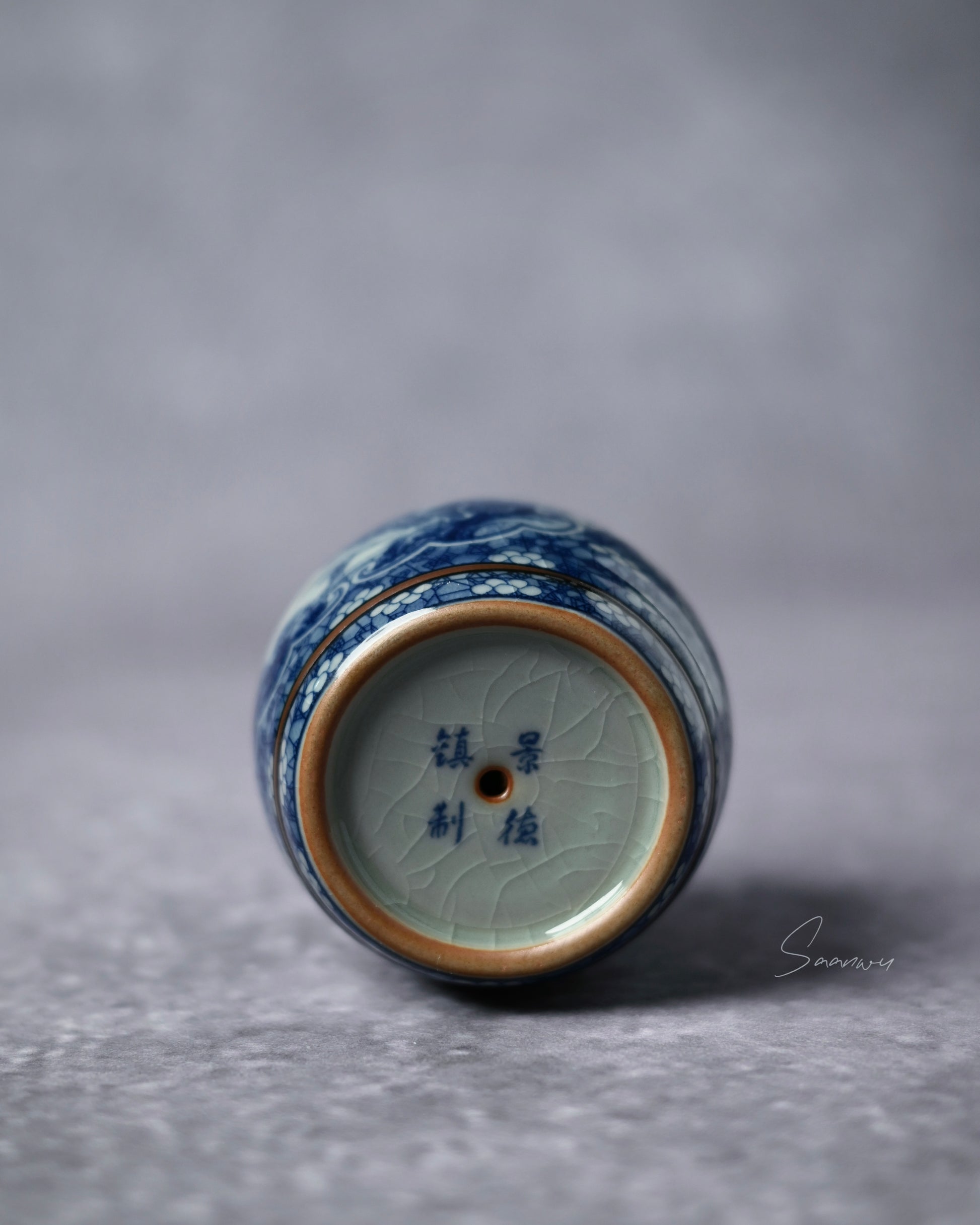 Hand-painted cobalt drum lid rest combining martial drum symbolism with scholarly landscape imagery