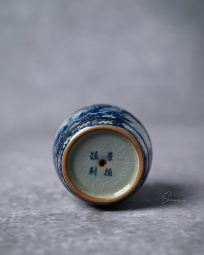 Hand-painted cobalt drum lid rest combining martial drum symbolism with scholarly landscape imagery