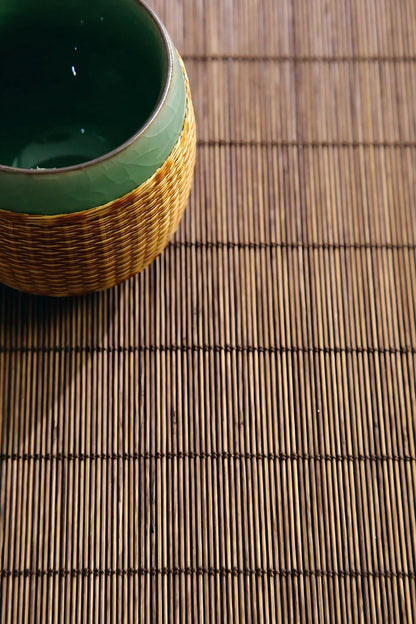 Hand‑woven bamboo‑sleeved Longquan Ge‑Yao celadon teacup for traditional Chinese gongfu tea ritual