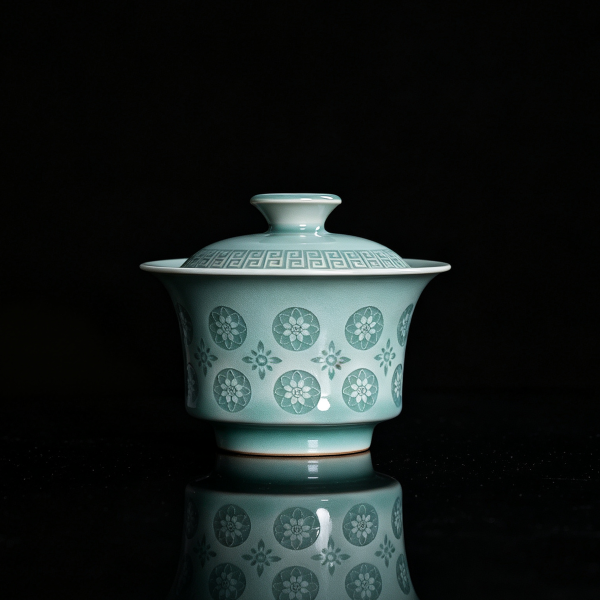 Traditional Chinese Longquan celadon lidded tea bowl with leiwen border lid and glowing pierced flower pattern