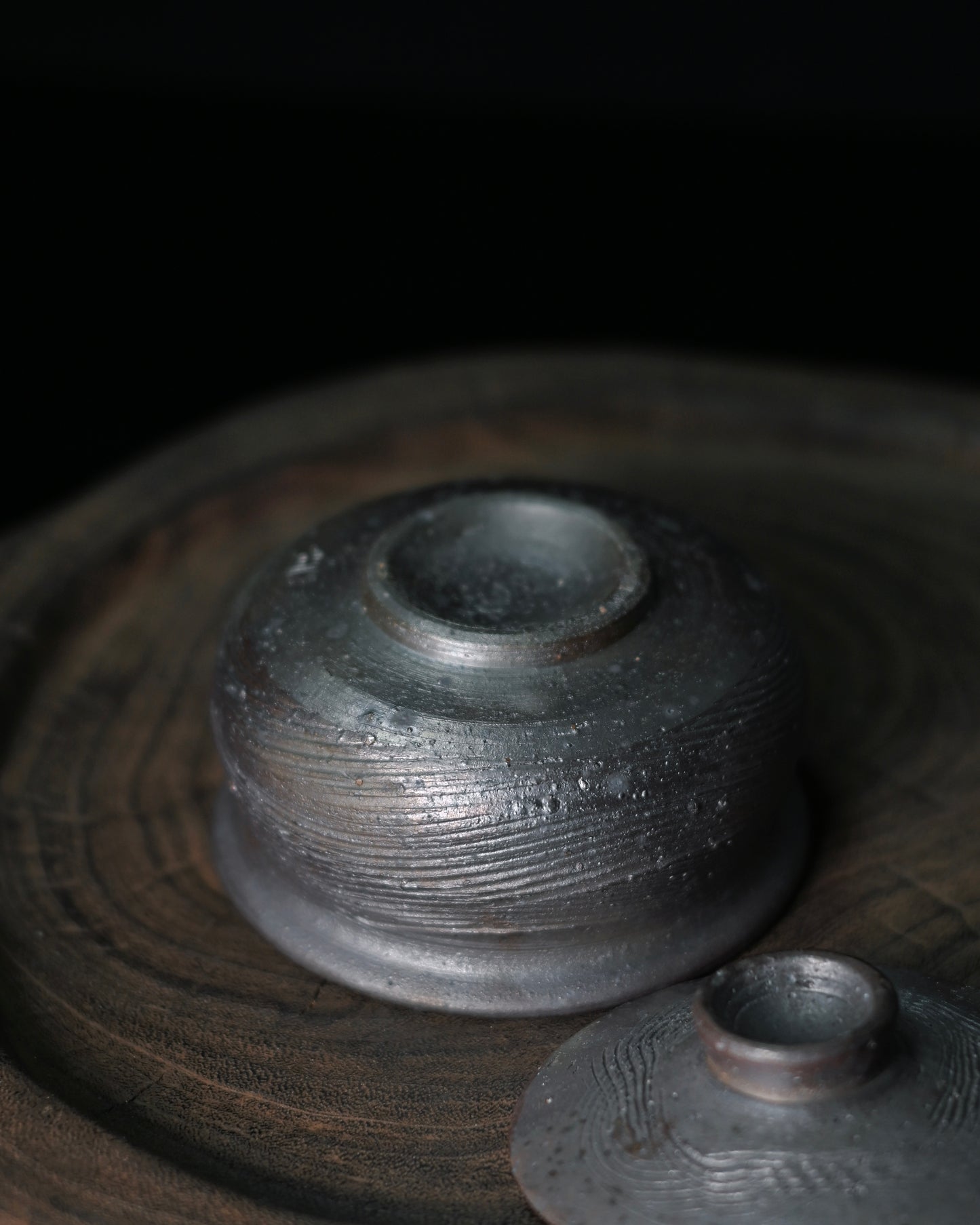 Hand-carved linear texture tea bowl showing incised grooves and ridges across the exterior surface