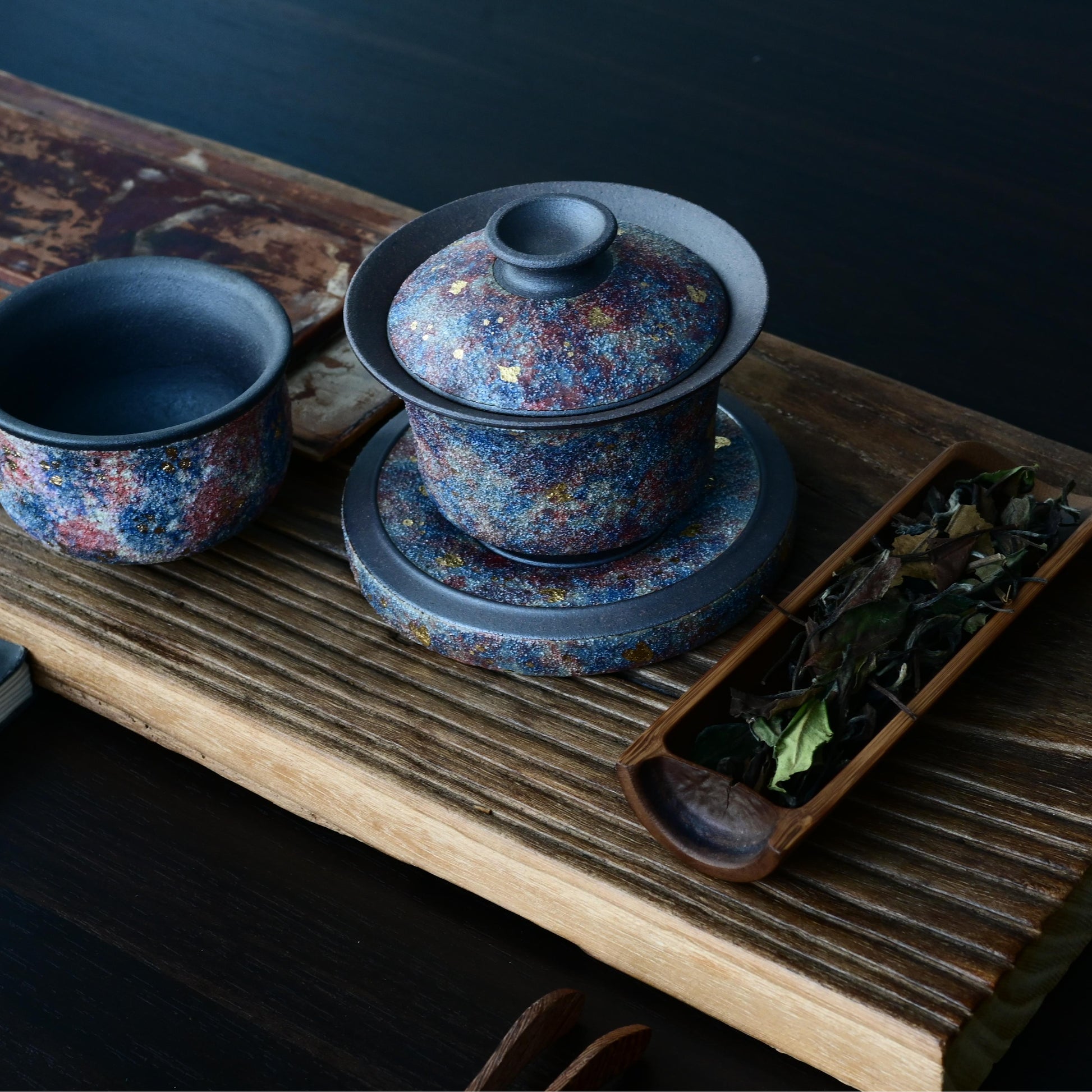 Luxury Yixing gaiwan featuring mineral gold decoration on aged purple clay, engineered to elevate both oolong and pu-erh tea experiences - the perfect connoisseur's gift.