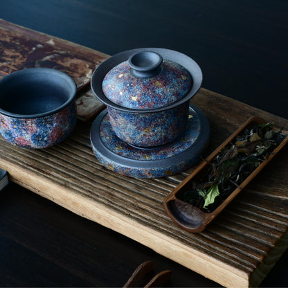 Luxury Yixing gaiwan featuring mineral gold decoration on aged purple clay, engineered to elevate both oolong and pu-erh tea experiences - the perfect connoisseur's gift.