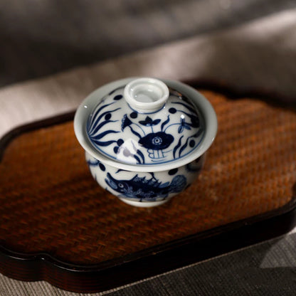 Top view of the gaiwan lid decorated with delicate hand-painted aquatic motifs and a round knob.