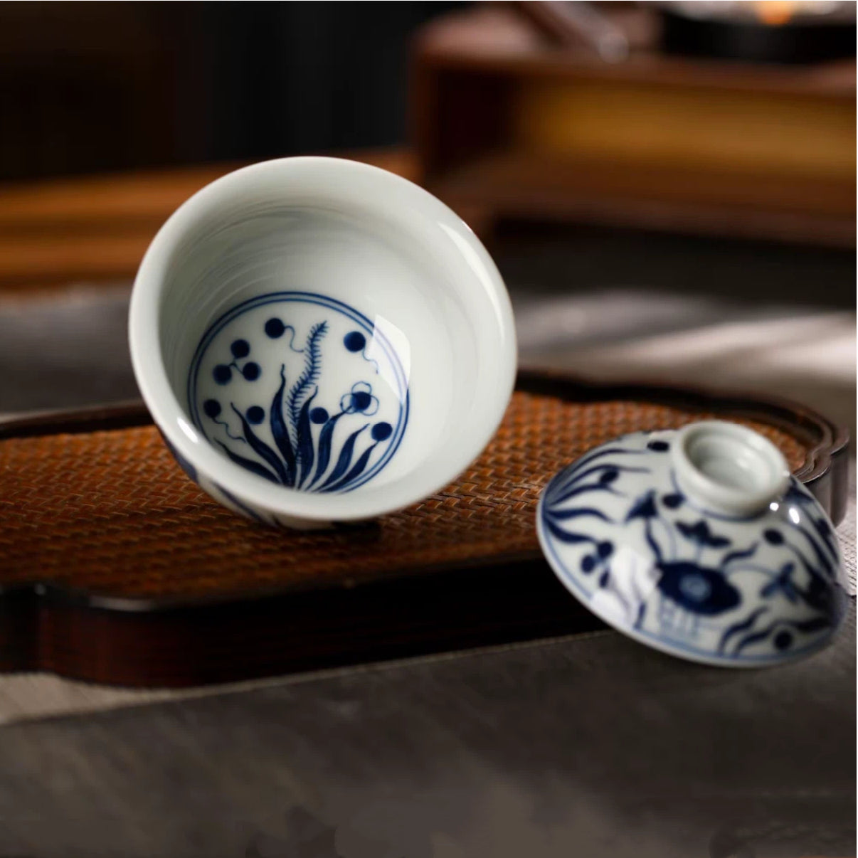 Top-down view of the smooth white porcelain interior and flared rim of the blue and white gaiwan.
