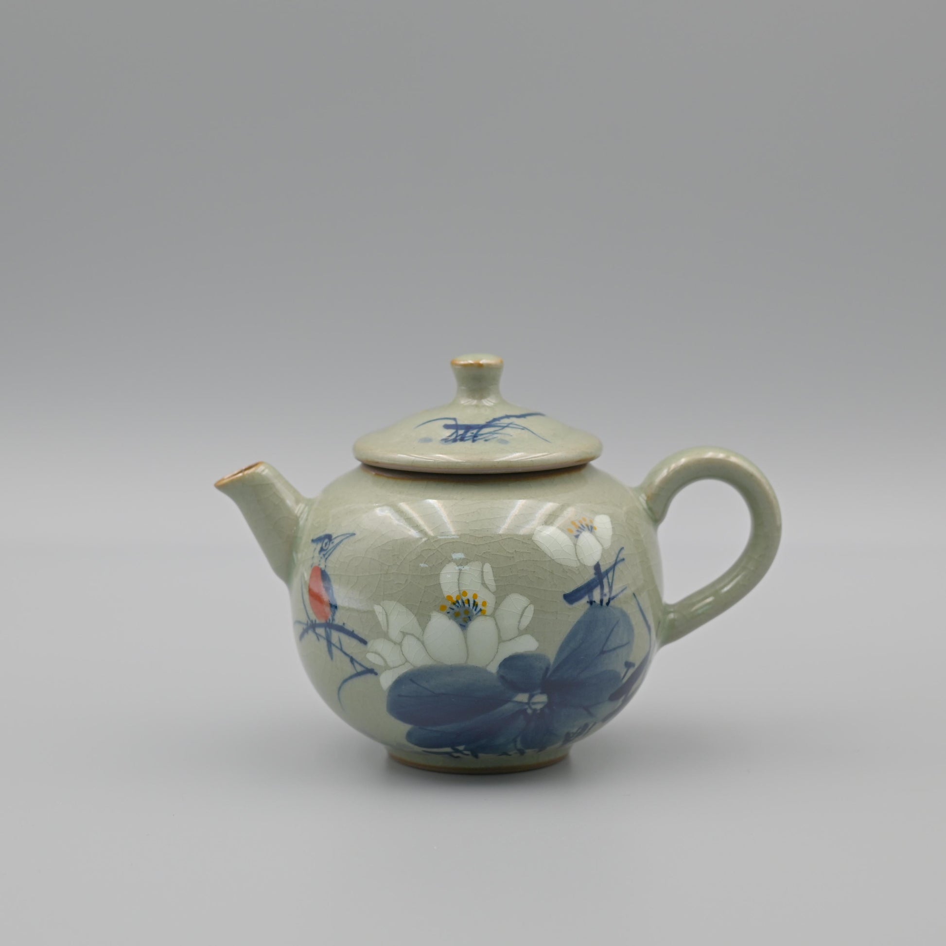 Lotus blue and white teapot with hand-painted floral design using underglaze techniques