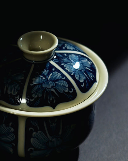 Hand-painted peony tea bowl where cobalt forms continuous background and flowers emerge in white