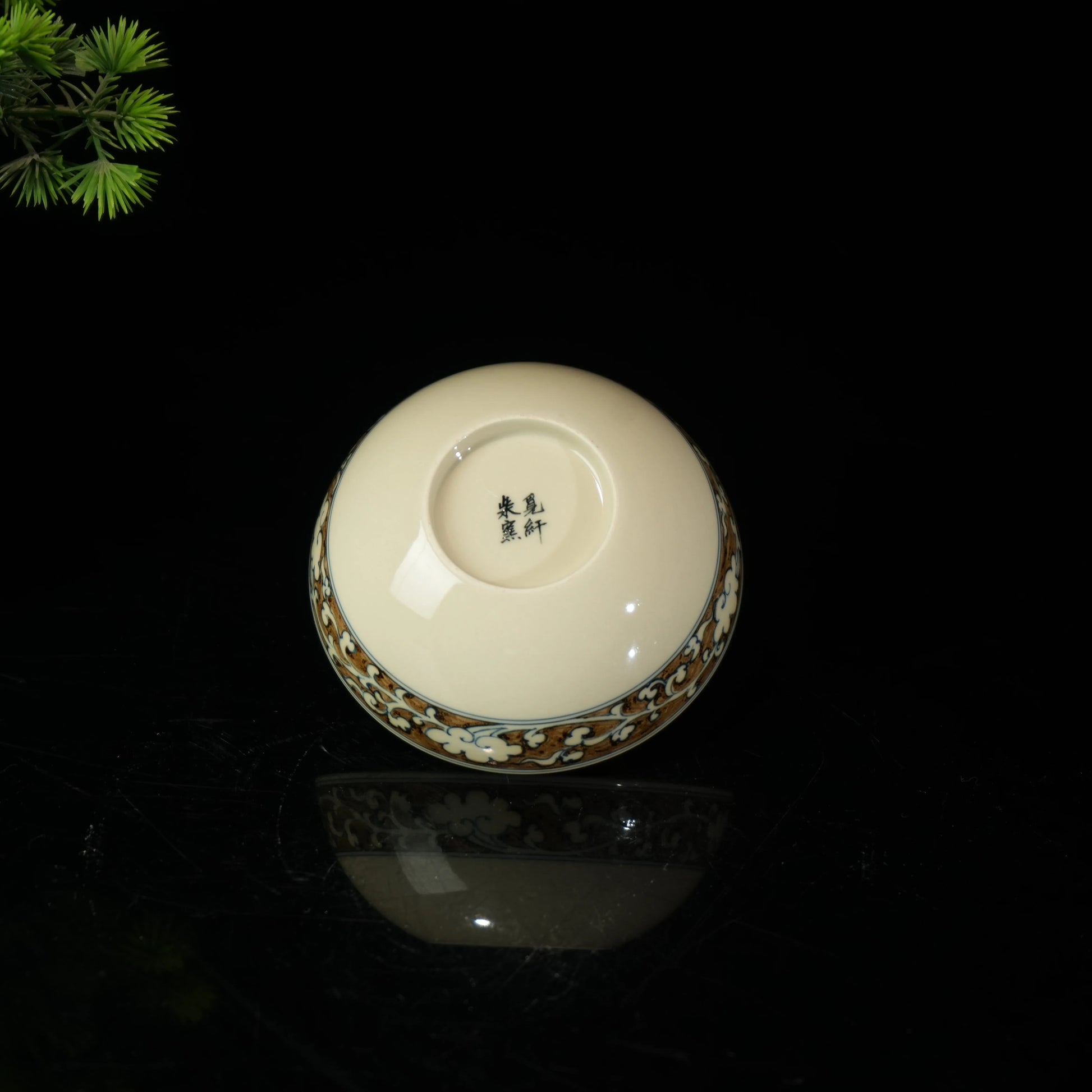 Luxurious Jingdezhen Pu'er teacup with gold detailing used in a traditional Gongfu tea ceremony