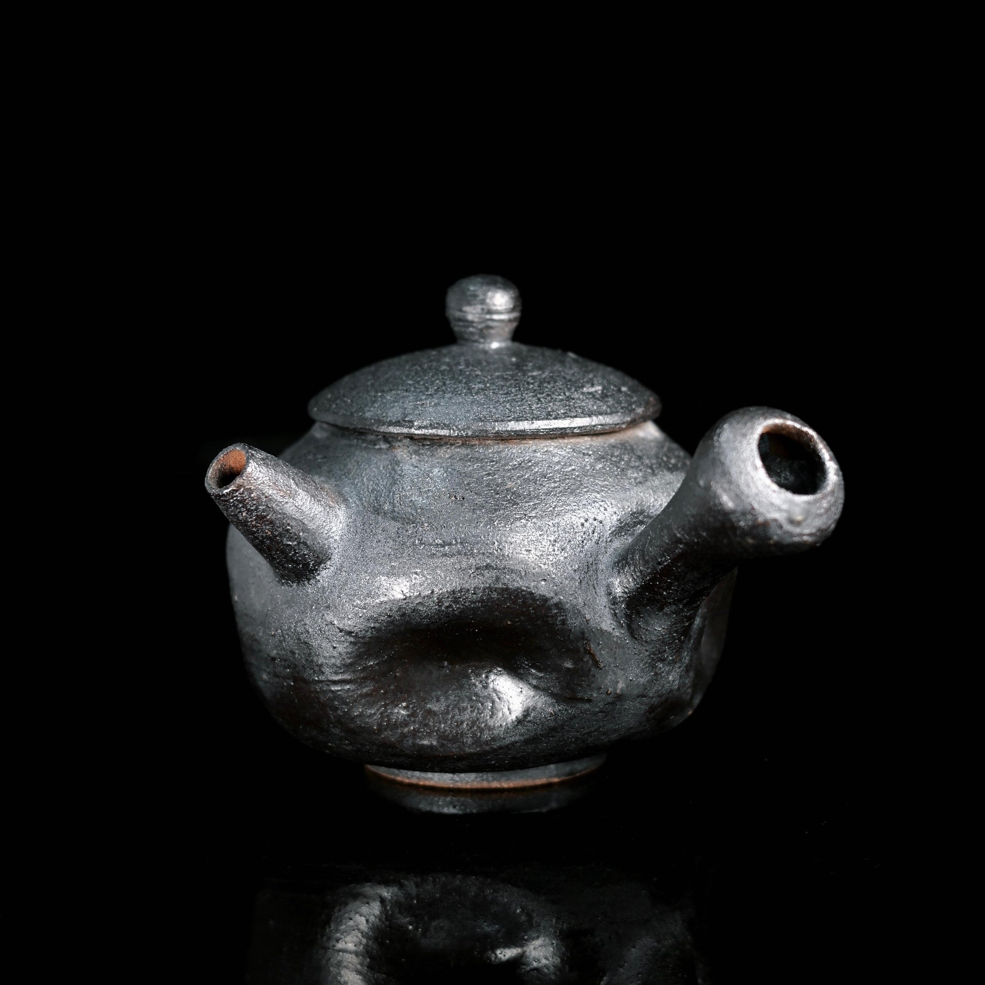 Hand-pinched coarse clay teapot shaped without molds using traditional pinching technique