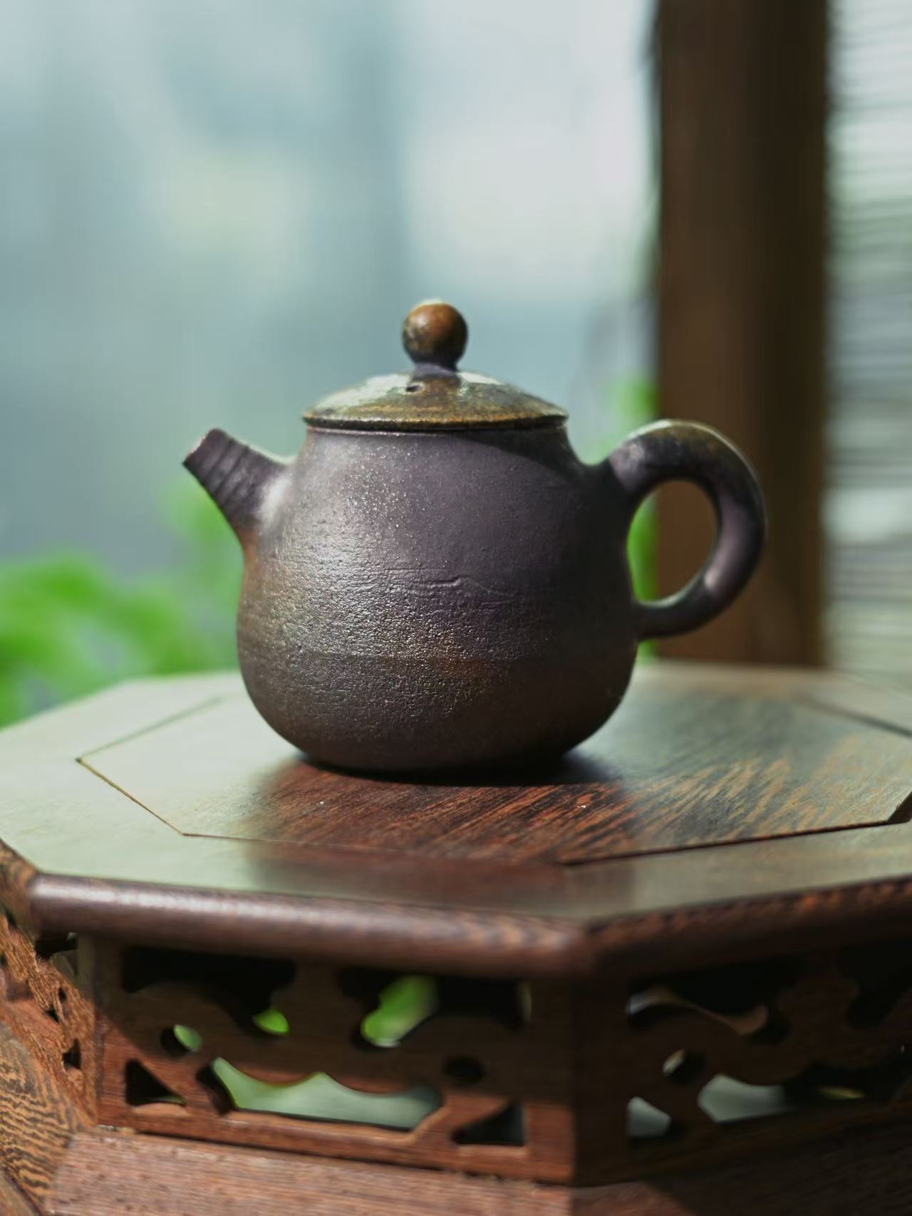 Side profile of the hand-crafted lid and textured body of the iron clay vessel.