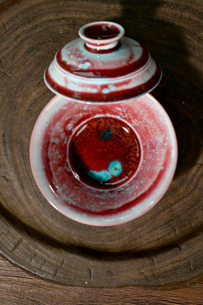 Handmade 1-of-1 soda-fired tea bowl with flame-red and turquoise glossy glaze finish