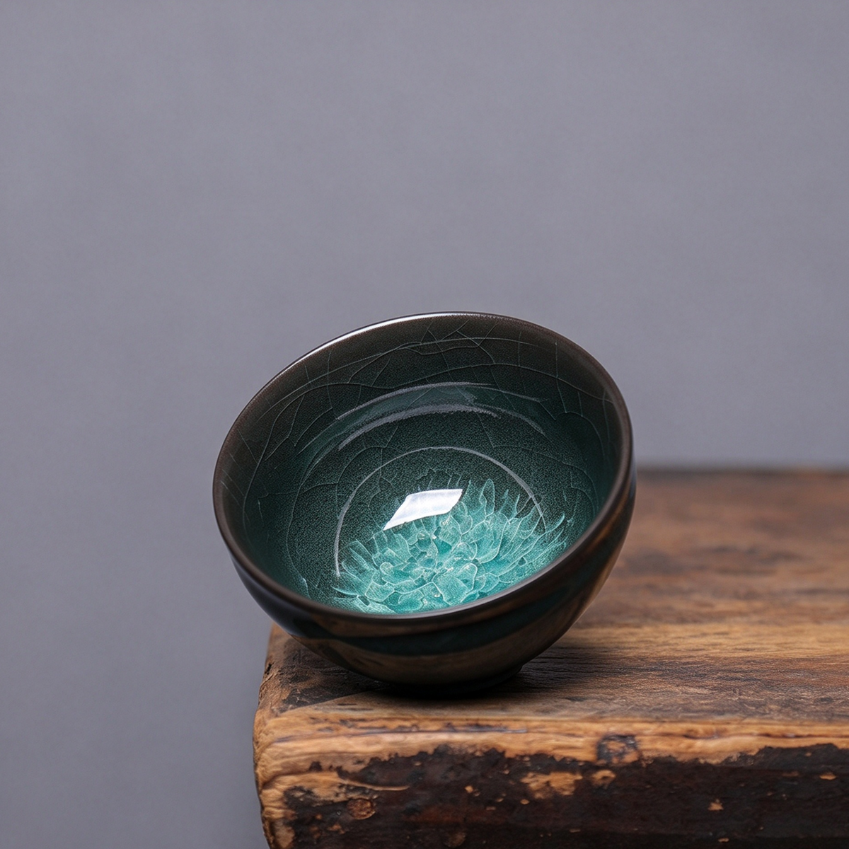 Top-down view of dark emerald green Longquan Celadon master cup with ice flake crackle bottom