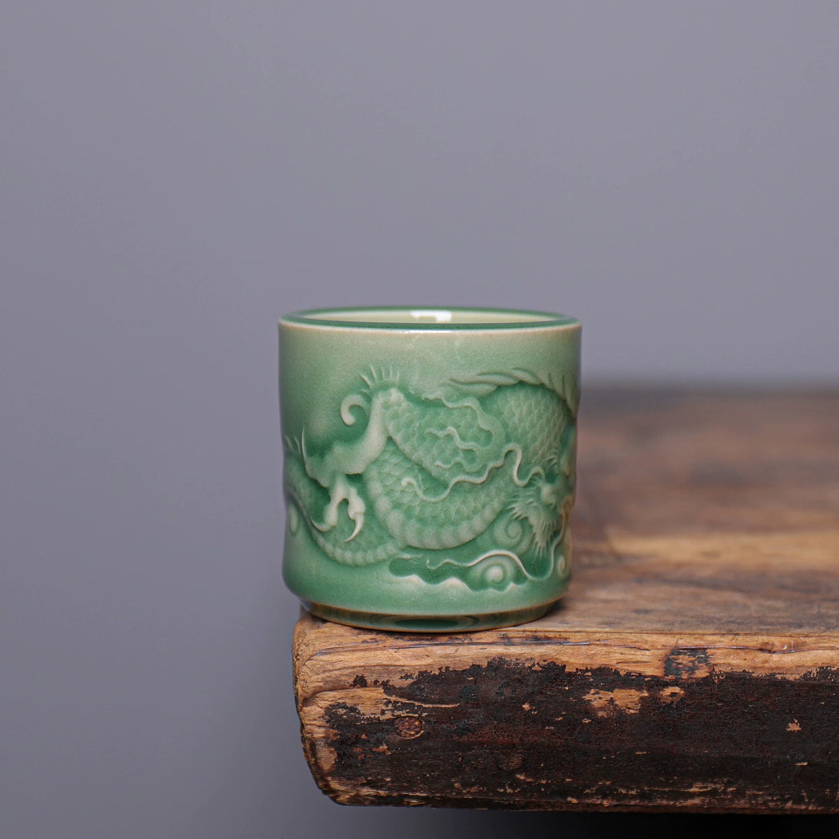 Close-up of sculpted dragon scales and cloud relief on handcrafted Longquan Celadon master cup