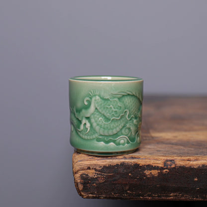 Close-up of sculpted dragon scales and cloud relief on handcrafted Longquan Celadon master cup