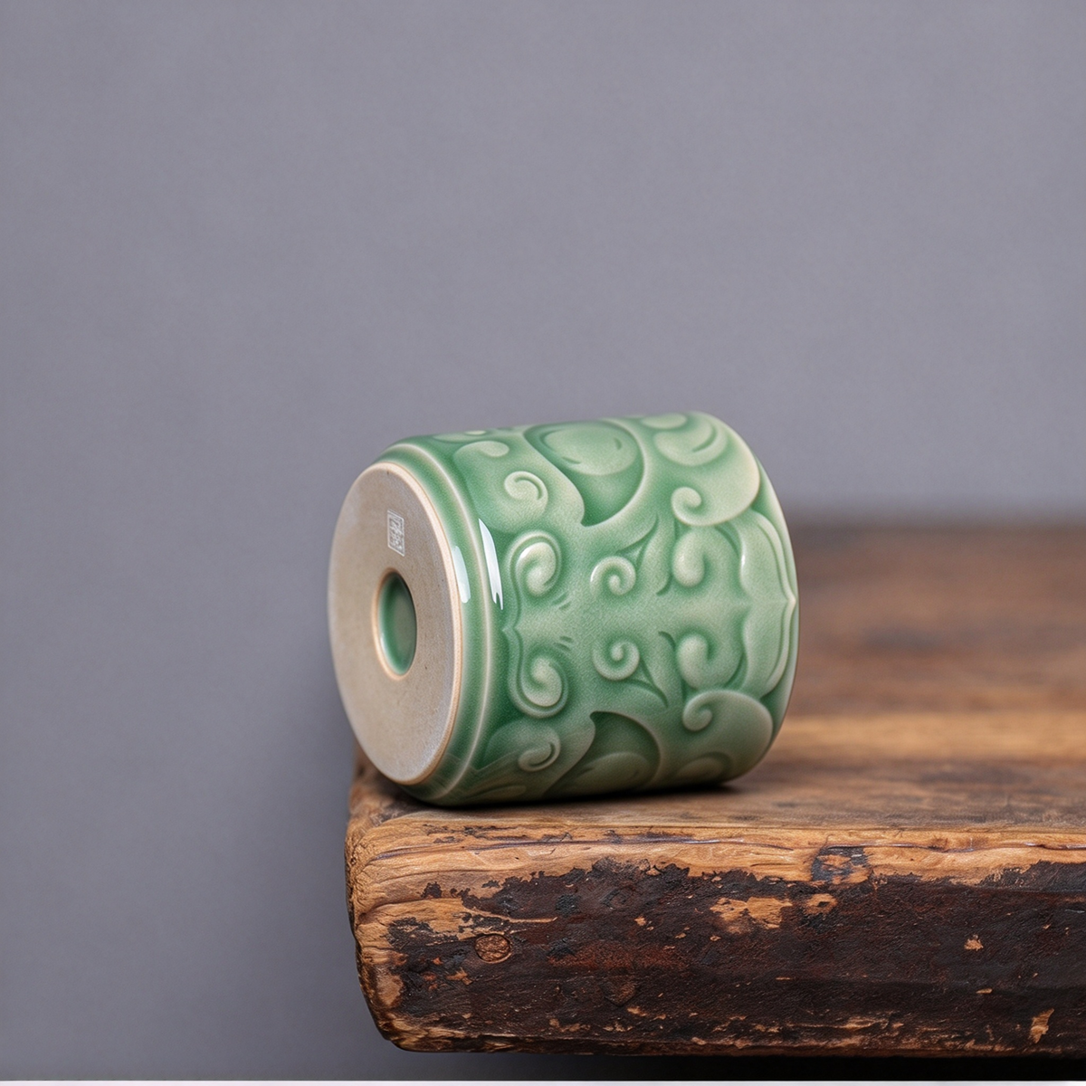 Close-up of sculpted bronze beast mask relief and celadon glaze on handcrafted Longquan Celadon master cup