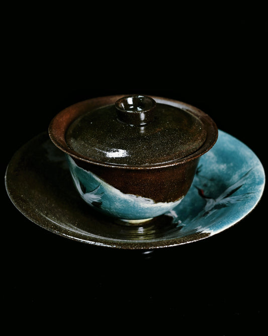 Handcrafted clay gaiwan with crane motif decoration