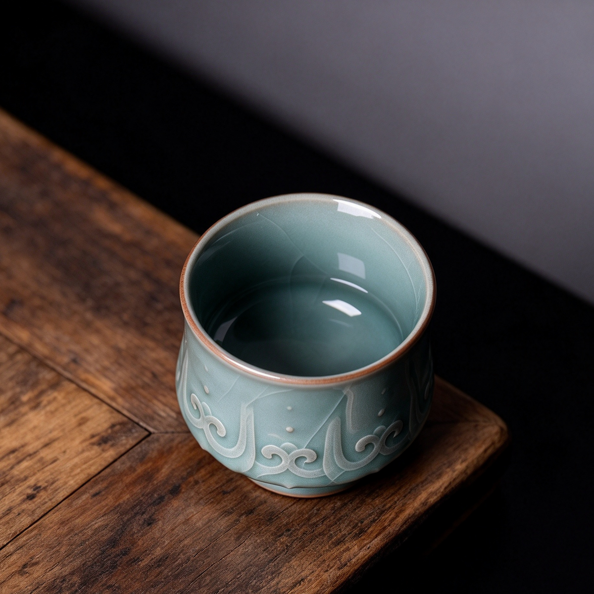 Close-up of hand-carved relief pattern and celadon glaze on Ge Kiln master tasting cup