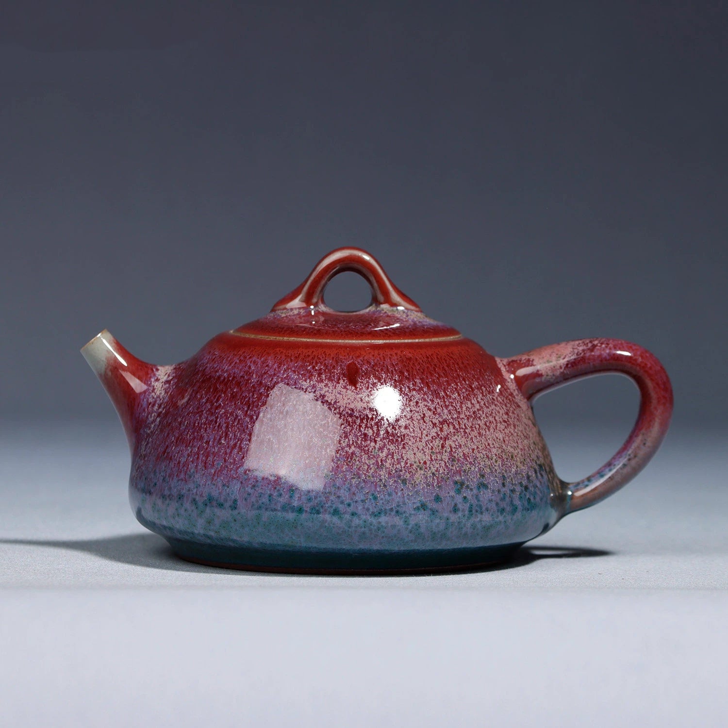 Handcrafted Jun Ware Lu Jun Glaze Shipiao Porcelain Teapot 200ML in a studio shot.
