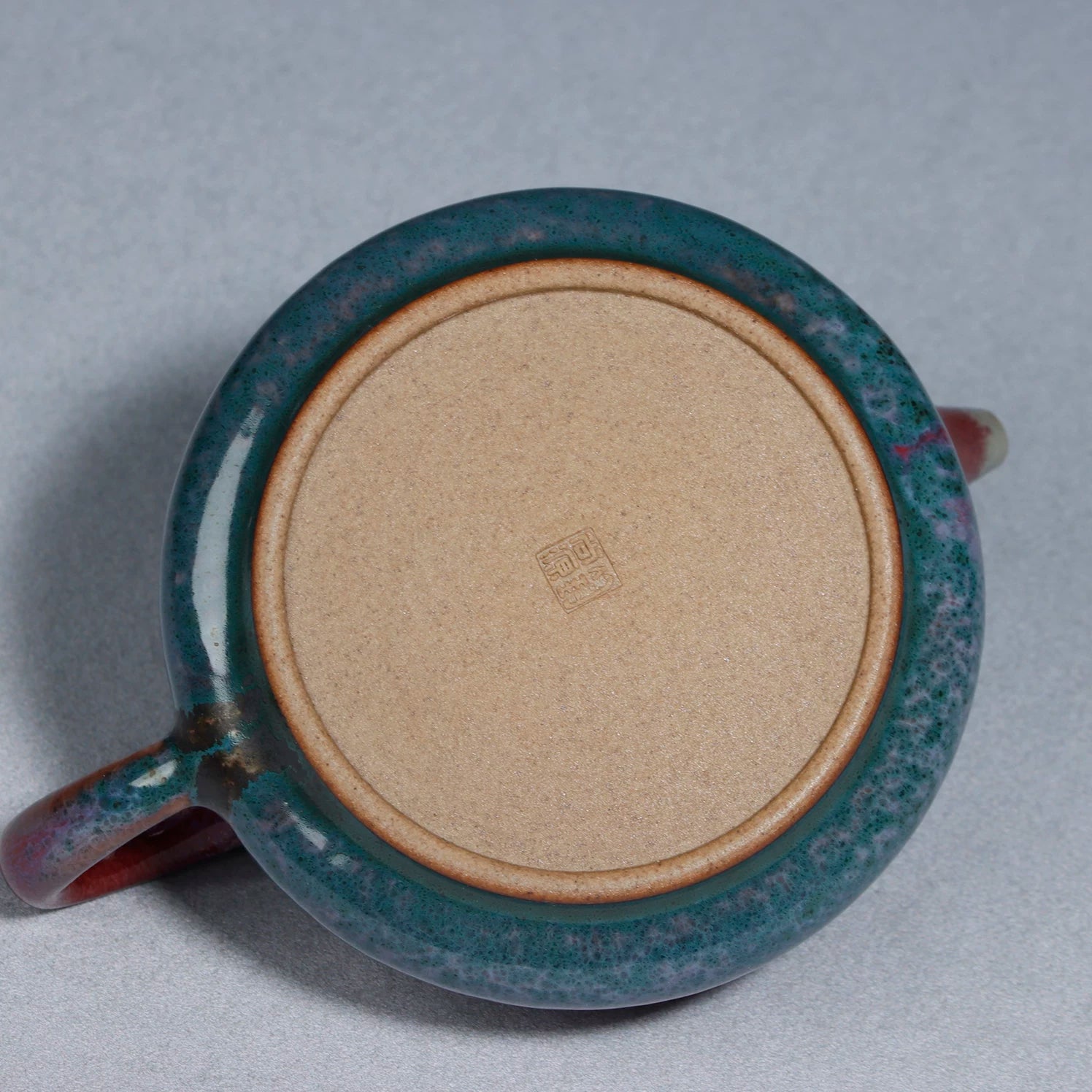 Bottom view showing the three sturdy feet and artisan hallmark of the 200ML Shipiao teapot.